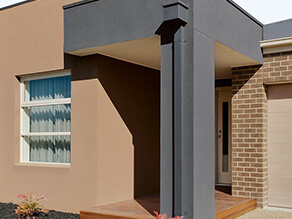 Brown painted Brick with Dark Grey Details and Timber Porch and Mulch Garden